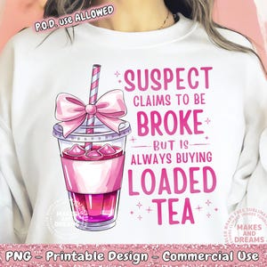 May include: A white sweatshirt with a pink graphic design of a pink and white boba tea cup with the text "SUSPECT CLAIMS TO BE BROKE BUT IS ALWAYS BUYING LOADED TEA".