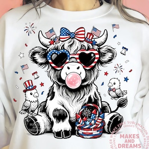 May include: White sweatshirt featuring a black and white cow illustration with patriotic sunglasses, a bow, and a bubblegum bubble. The design includes fireworks, flags, and birds, celebrating Independence Day.