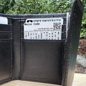 A plastic card entitled "Morse Code" inside a wallet pocket.