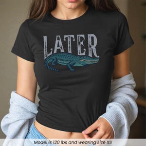 Woman wearing black "Later Gator" Vintage 90s Y2K Baby Tee.