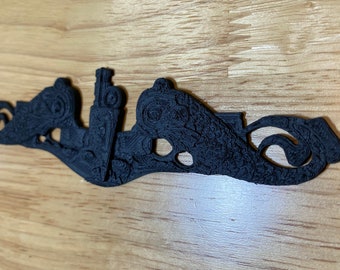 May include: A black, intricately detailed, 3D printed submarine pendant. The pendant features a submarine with a periscope and a detailed design on the hull.
