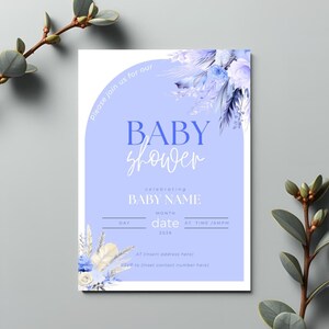 May include: A baby shower invitation with a light blue background and floral accents. The invitation includes the words "BABY shower" in a script font, along with space to add the baby's name, date, and address.