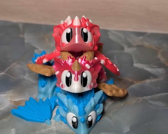 May include: Three stacked dragon figurines. The bottom dragon is blue, the middle dragon is pink and white, and the top dragon is red. The dragons have large eyes and are made of plastic.