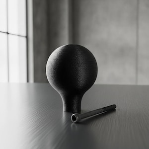 May include: A matte black spherical knob with a textured surface and a tapered base, accompanied by a single long black metal bolt with a cylindrical head. The knob features a visible layered finish consistent with 3D printed construction.