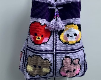 May include: Purple crocheted tote bag with a drawstring closure and a purple tassel. The bag features four different cartoon characters in a grid pattern: a red heart, a yellow character with a black nose, a brown character with a black nose, and a pink character with a black nose.