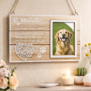 May include: Wooden pet memorial frame with a photo of a golden retriever. The frame has a white border and includes the name "Michelle", paw prints, and a heart-shaped string art design. Text reads "The thought of my faithful friend with it diminish. You are not by my side but always in my heart."