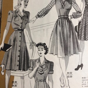 May include: A vintage sewing pattern for a jumper dress with a collared neckline and short sleeves. The pattern is available in sizes 12-20 and costs $4.50. The pattern is shown on three models wearing the dress.