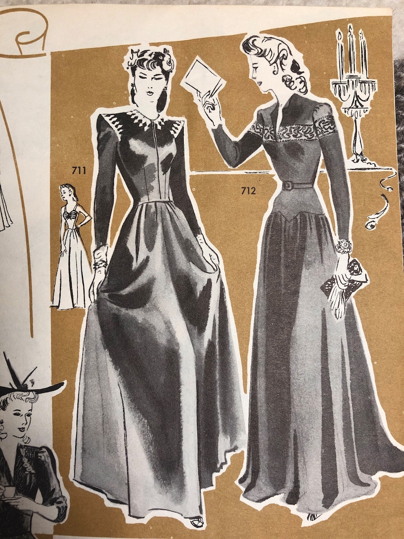 May include: Two women wearing long, black dresses with white trim. The woman on the left is holding a white card. The woman on the right is holding a small, white purse. The image is from a vintage sewing pattern book. The numbers 711 and 712 are visible in the image.