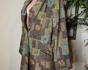 May include: A long-sleeved blazer featuring a patchwork pattern of brown wavy lines, light green squares, and teal squares, each accented with a gold leaf motif. The garment has a notched lapel, a single-breasted front, and two front pockets.