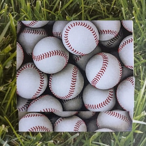 May include: A square image showing a close-up of several baseballs. The baseballs are white with red stitching. The background is a blurred green, resembling grass. The image is a close-up of the baseballs.