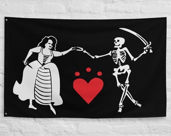 May include: A black pirate flag with a white skeleton and a woman dancing with a red heart in the center. The skeleton is holding a sword and the woman is holding a knife.