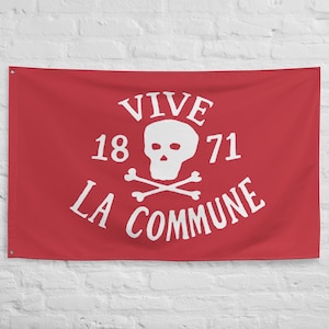 May include: Red flag featuring white text and a skull and crossbones emblem. The text reads "VIVE LA COMMUNE" with the year "1871" above the skull. The flag has grommets for hanging.