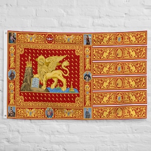 May include: A red flag with a gold winged lion standing on a rock holding a scroll with the text "Pax tibi Marce Evangelista Meus" in Latin. The lion is surrounded by a gold border with a repeating pattern of keys and other decorative elements. The flag has a gold border with a repeating pattern of figures and decorative elements.