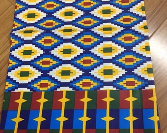 May include: A colorful fabric with a geometric pattern in shades of blue, yellow, red, and green. The fabric has a repeating pattern of diamonds and squares. The fabric is labeled "SUPER MCK" and "A2000905".