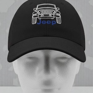 May include: Black baseball cap featuring a white embroidered Jeep logo on the front. The word "Jeep" is embroidered in blue below the logo. The cap has a curved brim and a structured crown.