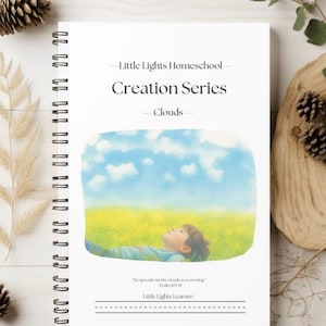 May include: A spiral-bound notebook with a white cover featuring the text "Little Lights Homeschool Creation Series - Clouds." The cover art depicts a child looking up at a blue sky with clouds. The notebook includes a quote from Psalm 105:39.