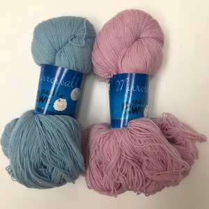 May include: Two skeins of yarn, one light blue and one light pink, with labels that say "Mirrorball good for ewe".