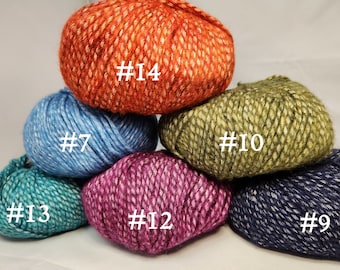 May include: Six balls of yarn in different colors, including orange, blue, green, purple, teal, and navy. Each ball has a white label with a number on it, ranging from #7 to #14.
