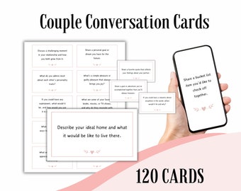 May include: A set of 120 conversation cards for couples, with prompts to spark discussion. The cards are displayed with a smartphone showing a bucket list prompt. The text "Couple Conversation Cards" is at the top.