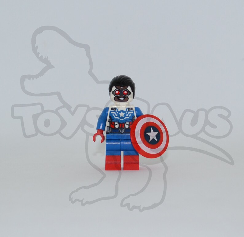 May include: A Lego minifigure of a superhero wearing a blue, red and white costume with a red, white and blue shield. The figure has black hair and a black mask with red goggles.