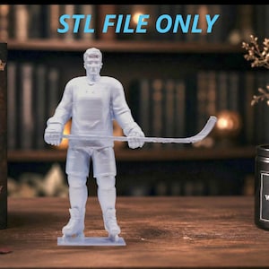 May include: A light blue 3D printed figurine of a hockey player standing on a rectangular base, holding a hockey stick horizontally. The text STL FILE ONLY is displayed in light blue above the figure. The figurine features a jersey, shorts, and skates.