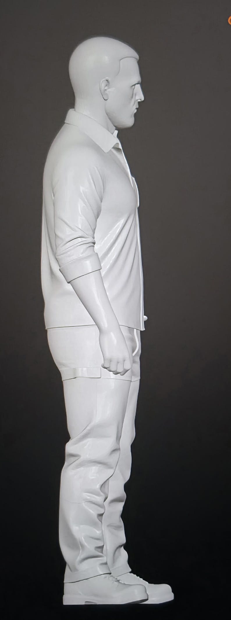 May include: A monochromatic white figurine of a person standing in profile. The figure wears a collared button-down shirt with rolled sleeves, trousers, and boots. The sculpture features a smooth, glossy finish and is presented against a dark background.