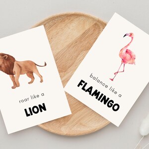 Set of two inspirational animal prints for kids with phrases ‘roar like a lion’ and ‘balance like a flamingo’ featuring watercolor illustrations and minimalist background.