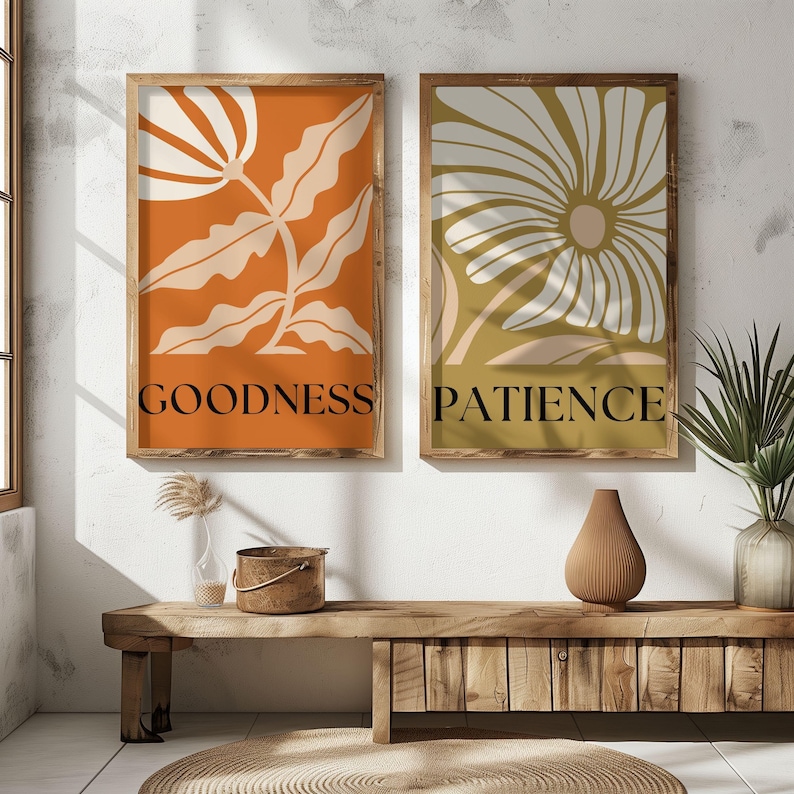 Earth-toned abstract flower art prints labeled “GOODNESS” and “PATIENCE,” framed and displayed in a cozy boho entryway with natural textures and sunlight.