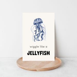 A white card with a blue watercolor jellyfish illustration. The text on the card reads 'wiggle like a JELLYFISH'.