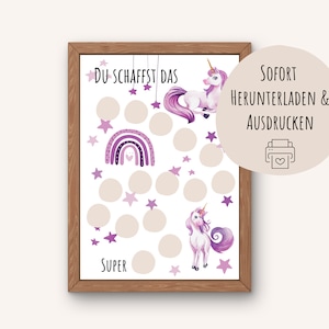 May include: A framed print with a unicorn, rainbow, and stars design. The print includes the text "DU SCHAFFST DAS" and "SUPER". The design is set against a white background with beige circles. The print is in a wooden frame.