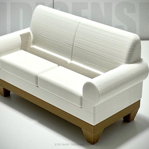 May include: White miniature sofa with a brown base. The sofa has a tufted back and rolled arms.