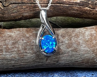 Collana in argento sterling con opale sintetico e ciondolo a forma di fiamma dai colori blu fuoco.