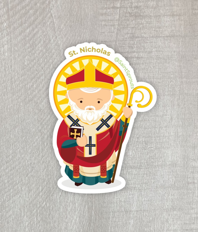 May include: A sticker featuring a cartoon illustration of Saint Nicholas, a white-bearded man wearing a red and gold bishop's robe, holding a book and a staff. The sticker has a yellow halo around his head and the text "St. Nicholas" and "@SaintSprouts" on it.