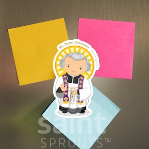 May include: A colorful sticker featuring a cartoon illustration of St. John Vianney, a Catholic priest, holding a rosary. The sticker has a yellow halo and the text "St. John Vianney @SaintSprouts" in green.
