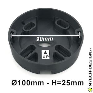 May include: A black, circular component with a diameter of 100mm (3.9 inches) and a height of 25mm (0.98 inches). It features multiple oval openings and a central hole. The text "UP" with an arrow is visible. The overall width is 90mm (3.5 inches).