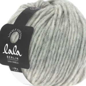 May include: A ball of gray and white yarn with a black label that reads "lala BERLIN LANA GRASSA 50 g"