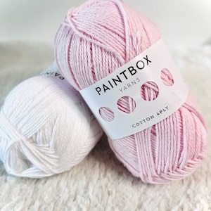 May include: Two balls of yarn, one white and one pink. The pink ball has a label that says "Paintbox Yarns Cotton 4ply".
