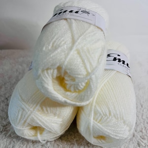 May include: Three balls of white yarn labelled "Emu Classic" with a knitting needle icon.