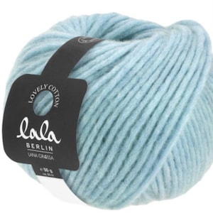 May include: A ball of light blue yarn with a black label that says "lala Berlin Lana Grossa" and "Lovely Cotton".