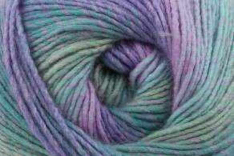 May include: Close-up of a skein of yarn in shades of teal, purple, and pale green. The yarn is tightly wound, revealing the texture of the fibers. The colors blend together, creating a soft, variegated effect, ideal for knitting or crocheting projects.