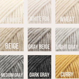 May include: Nine yarn skeins in various shades of white, beige, gray, and yellow. The colors are labeled "Off White", "White Fog", "Wheat", "Beige", "Gray Beige", "Light Gray", "Medium Gray", "Dark Gray", and "Curry".