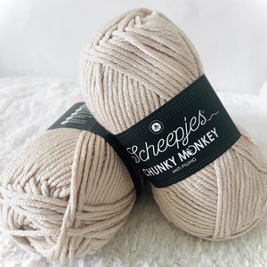 May include: Two balls of beige yarn labeled "Scheepjes Chunky Monkey Anti Pilling"