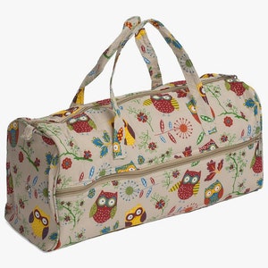 May include: A beige canvas travel bag with a double zipper closure and two top handles. The bag features a colorful owl and floral print.