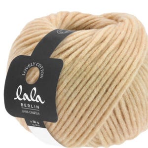 May include: A ball of beige yarn with a black label that reads "Lovely Cotton Lala Berlin Lana Grossa 50 g".