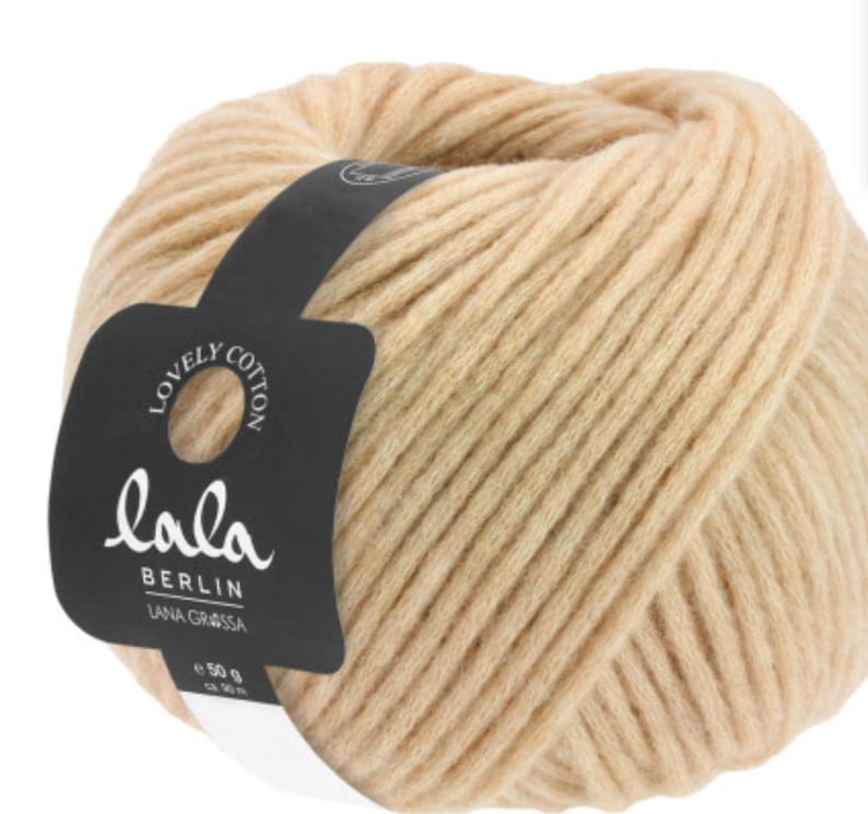 May include: A ball of beige yarn with a black label that reads "Lovely Cotton Lala Berlin Lana Grossa 50 g".