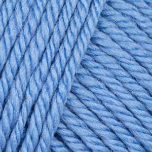 May include: Close-up of a skein of light blue yarn. The yarn is soft and fluffy, and it is perfect for knitting or crocheting.