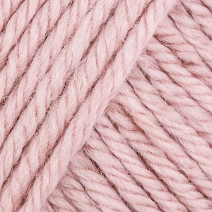 May include: Close-up of a soft, pink yarn skein. The yarn is made of natural fibers and has a fuzzy texture.