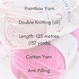 May include: Close-up of two skeins of yarn in shades of pink. The labels read "Paintbox Yarn", "Double Knitting (dk)", and "Cotton Yarn". The length is 137 yards. The text "Anti Pilling" is also visible.