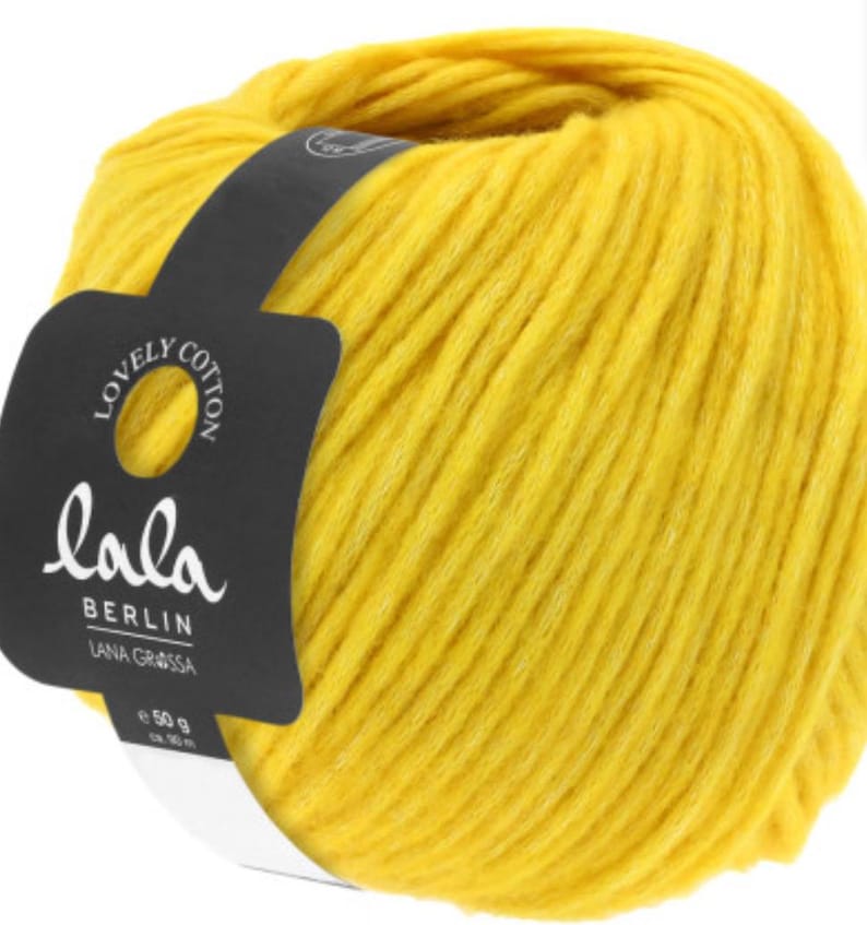 May include: A ball of yellow yarn labeled "lala Berlin Lana Grossa Lovely Cotton" with a white label indicating 50g and 95m.