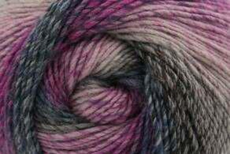 May include: Close-up of a ball of yarn with a blend of colors. The yarn features shades of pink, purple, gray, and blue. The fibers are tightly wound, creating a textured appearance. This yarn is suitable for knitting and crochet projects.